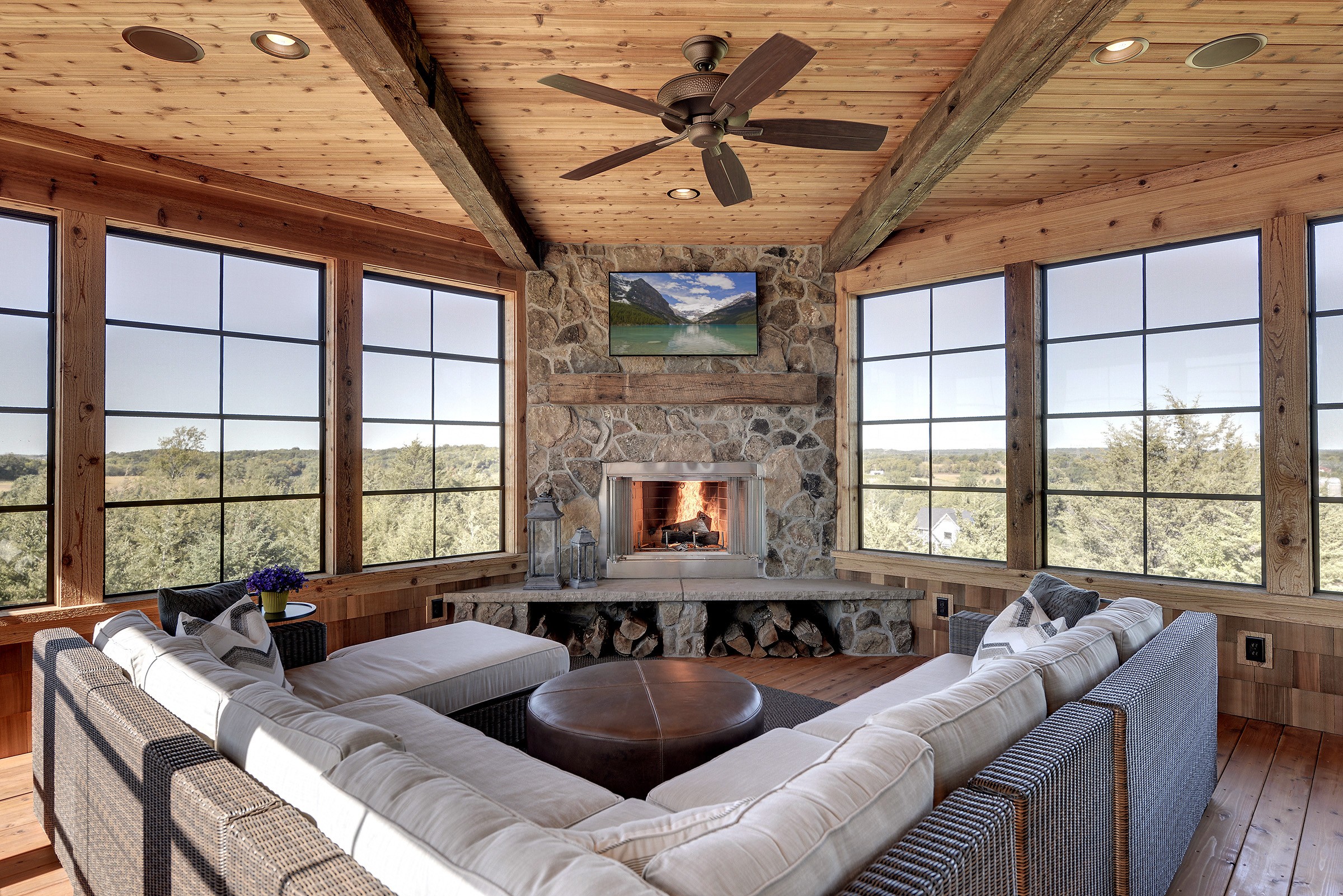 Xtend Porch Windows in cabin porch with knotty pine ceiling and stone fireplace